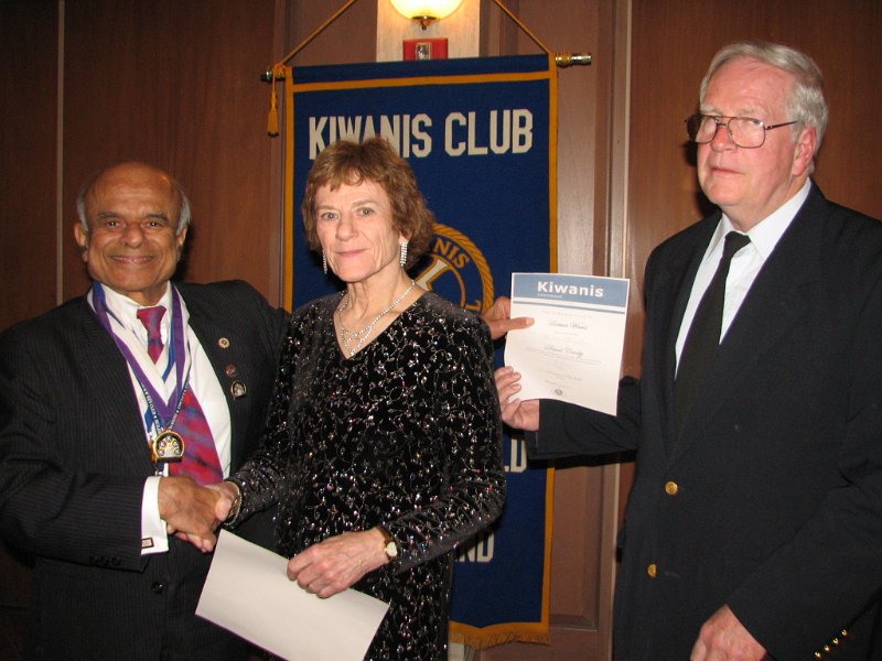 IMG_0324.JPG - Here’s how it is done.  Governor Tom installs the first two of five new members to become Kiwanians this night.  George Chacko, again, brings in a new member, Carolyn Sieradzski.  Also, David Crosby (right) was installed and was sponsored by Phoebe Clark. Both are new members for the Leisure World Club and Kiwanis.