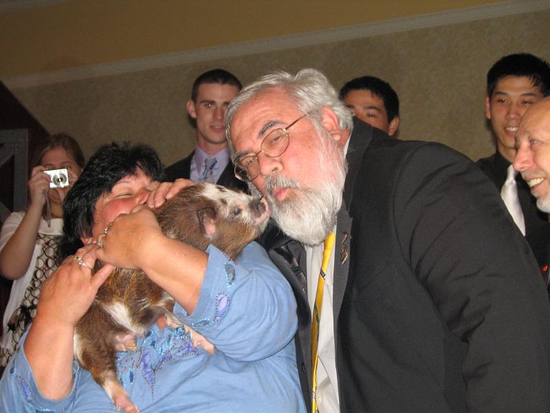 IMG_2605.JPG - Key Club Administrator Joe Stankus gave his kiss to a squealing little pig and an equally squealing and laughing crowd.  The pig lives at Broken Road Farm.