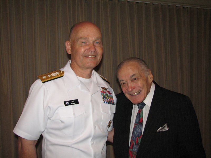 IMG_7782.JPG - RADM ‘Buz’ Buzby thanks World War II veteran SSGT Bob Vigderhouse for his service to his country.  Bob was a U.S. Army medic landing at Normandy on D Day Plus 2.  Bob was awarded a Bronze Star for heroism and a Purple Heart for service during the Battle of the Bulge in December 1944 to January 1945.