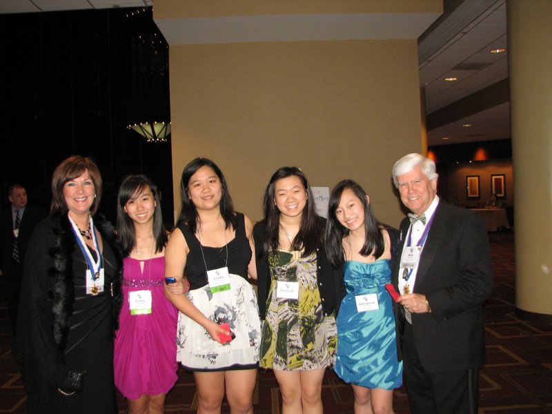 IMG_0775.JPG - Saturday night brings the long awaited semi-formal/formal “Awards Banquet Dinner”.  It is the opportunity for all 1,000+ (Can you believe it?  Believe it.) attendees to gather in the Regency Ball Room. So, put on your best and let’s go!  The Potomac Kiwanis Club sponsors the Winston Churchill Key Club in Potomac, Maryland.  Left to right is Key Club Advisor and President Nancy Cressy, Key Club President Cindy Zheng, Cindy Yiin, Hannah Sur, Adrianna Lee, and Key Club Advisor PG Bob Cressy (Potomac Club Secretary).  Ladies, you all look lovely.  Bob … well …