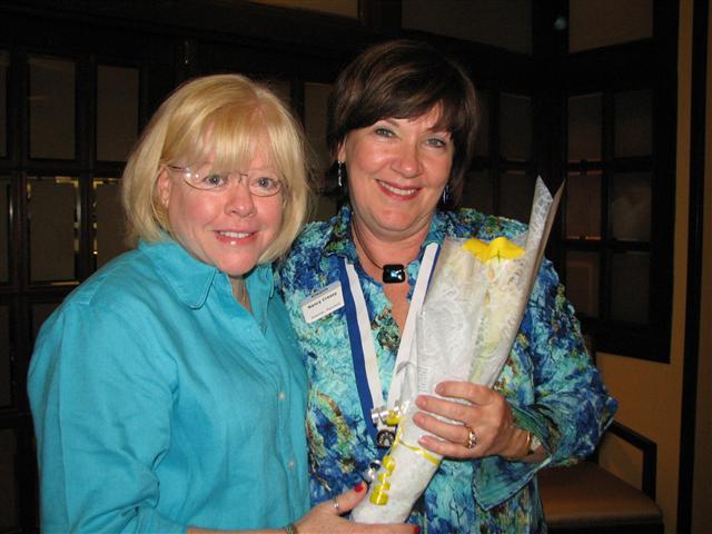IMG_9310.JPG - Potomac Club Director Beth Bentolia presents President Nancy Cressy a bouquet of flowers in congratulations from the club membership.  You have a great team, committed service projects and strong support of all members.  Especially proud of Nancy is PG Bob Cressy.