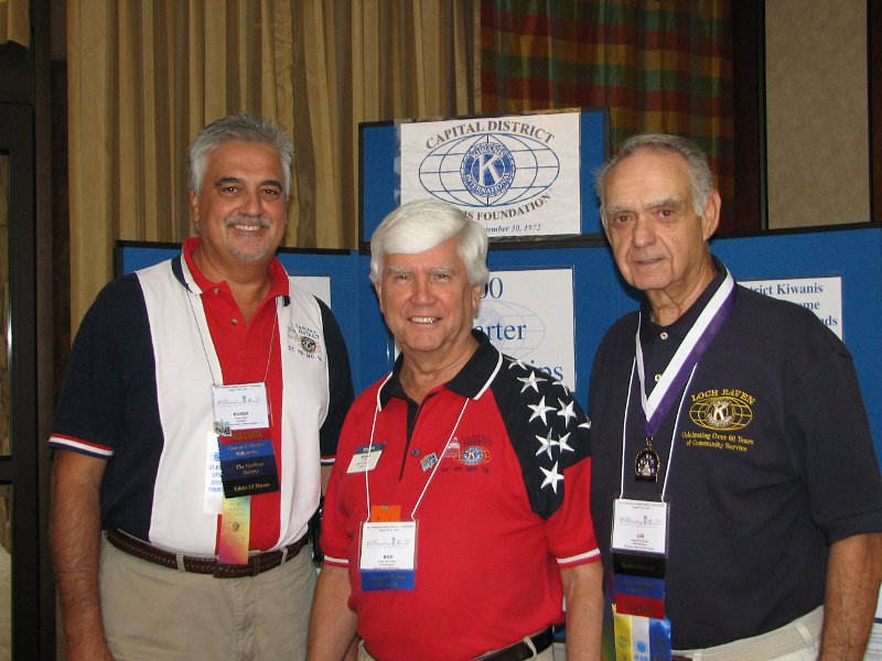 IMG_5108.JPG - After breakfast, attendees were off to visit the exhibits and to chose which of the many club workshops members will attend. The CDKF – Capital District Kiwanis Foundation had it’s both just outside the breakfast room. Past CDKF Presidents Roger Diehl and Joe Moranto flank PG & past CDKF VP Bob Cressy as they man the exhibit booth and answer questions. The Foundation is our tax-exempt 501c3 charitable arm to help fund our Service Leadership Programs and provide some grants to clubs for their worthy projects. Funds are invested in an endowment with the earnings used for projects. Did you know that club donations of $2.00 per member has added up to more than $268,000 over the years? And that the Founder’s Society membership added another $110,000? All funds stay within the District as we continue to support the Kiwanis International Foundation as well.